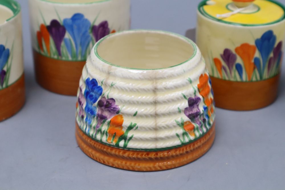 Five Clarice Cliff crocus preserve jars and two covers, tallest 8.5cm